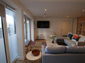 A living room with a tv and sofa at 11 Fountain Court in Falmouth