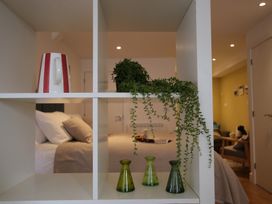 A bedroom with a kettle and vases on a shelf at 11 Fountain Court in Falmouth