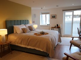 A bedroom with a bed and a tray on it at 11 Fountain Court in Falmouth