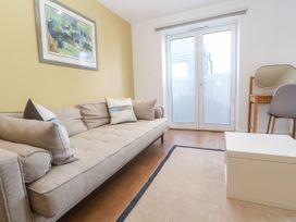 A living room with a sofa and table at 11 Fountain Court in Falmouth