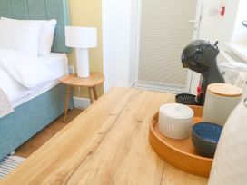 A bedroom with a bed and a coffee maker on a table at 11 Fountain Court in Falmouth