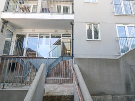 An outdoor view of stairs leading to a balcony at 11 Fountain Court in Falmouth