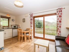 A kitchen with a table and chairs at Orchard Cottage in Ledbury