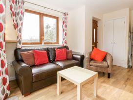 A living room with a sofa and coffee table at Orchard Cottage in Ledbury