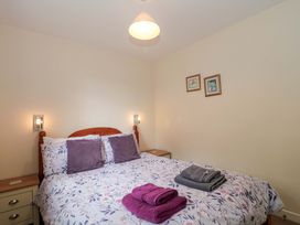 A bedroom with a bed and bedside table at Orchard Cottage in Ledbury