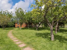 A house with trees and a pathway at Orchard Cottage in Ledbury