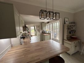 A kitchen with cabinets countertops and a window at Somerby in St. Bees