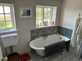 A bathroom with a bathtub and a toilet at Somerby in St. Bees