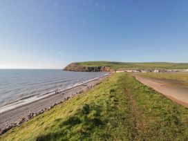 A beach along the ocean with a pathway in the background at Somerby in St Bees