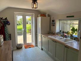 A kitchen with a sink and fridge at Somerby St Bees