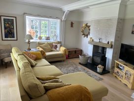 A living room with a sofa and fireplace at Somerby in St Bees