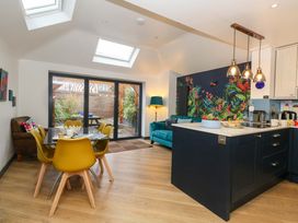 A kitchen with dining table and chairs at Still Waters in Weymouth