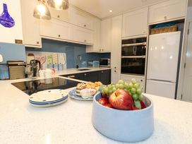 A kitchen with a fruit bowl and kitchen appliances at Still Waters in Weymouth