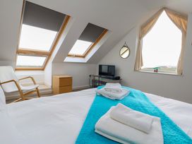 A bedroom with a bed and a television at Still Waters in Weymouth