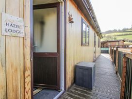 An entrance area of Hazel Lodge in Clunton near Clun with a wooden door and walkway