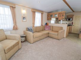 A living room with a sofa and a coffee table at 11, Beachfields
