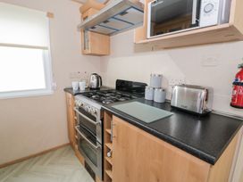 A kitchen with appliances and utensils at 11, Beachfields