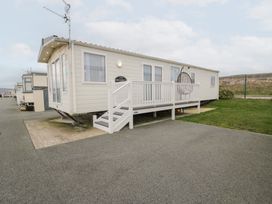 A caravan with a deck and steps at 11, Beachfields