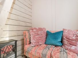 A sofa with cushions in a snug at Shades Farm Cabin in Cirencester