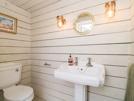 A bathroom with a sink and toilet at Shades Farm Cabin in Circenester