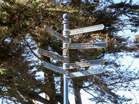 A signpost with directions to various locations at Upper Longlands in Dawlish