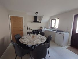 A kitchen with a dining table and chairs at Upper Longlands in Dawlish