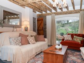 A living room with a sofa and coffee table at Garden Cottage at the Bowden Estate Stoke Fleming