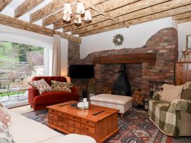 A living room with a sofa and fireplace at Garden Cottage at the Bowden Estate Stoke Fleming