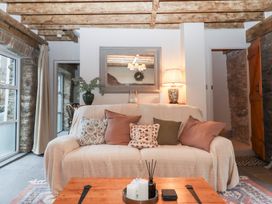 A living room with a sofa and coffee table at Garden Cottage at the Bowden Estate Stoke Fleming