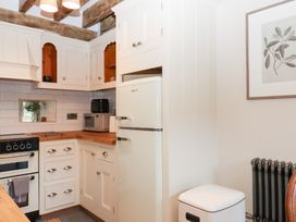 A kitchen with appliances and cabinets at Garden Cottage at the Bowden Estate Stoke Fleming