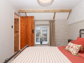 A bedroom with a bed and window at Garden Cottage at the Bowden Estate Stoke Fleming