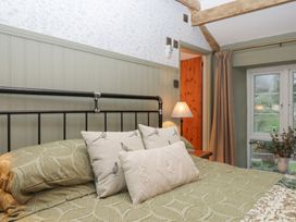 A bedroom with a bed and window at Garden Cottage at the Bowden Estate Stoke Fleming