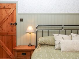 A bedroom with a bed and bedside table at Garden Cottage at the Bowden Estate Stoke Fleming