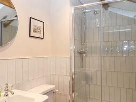 A bathroom with a shower and sink at Garden Cottage at the Bowden Estate, Stoke Fleming