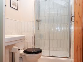 A bathroom with a shower and toilet at Garden Cottage at the Bowden Estate Stoke Fleming