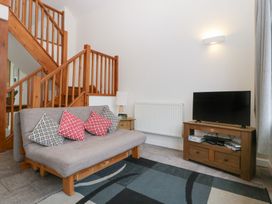 A living room with a sofa and television at Horse Gin in Lydney