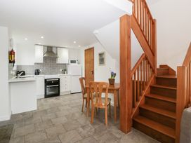A kitchen area with a table and chairs at Horse Gin in Lydney