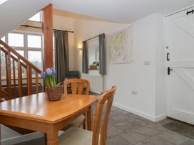 A dining room with a table and chairs at Horse Gin in Lydney