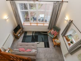 A living room with a sofa and television at Horse Gin in Lydney