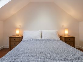 A bedroom with a bed and nightstands at Horse Gin in Lydney