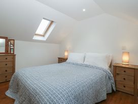 A bedroom with a bed and nightstands at Horse Gin in Lydney