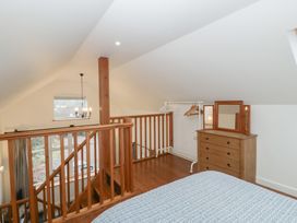 A bedroom with a bed and dressing table at Horse Gin in Lydney