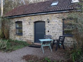 A stone cottage exterior with a table and chairs at Horse Gin in Parkend