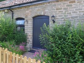 An entrance with plants and a wooden fence at Horse Gin in Parkend
