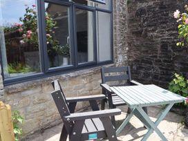 An outdoor seating area with a table and chairs at Horse Gin in Parkend