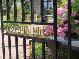 A garden gate with flowers and a path at Horse Gin in Parkend