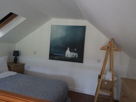 A bedroom with a bed, lamp, and painting at Horse Gin, Parkend