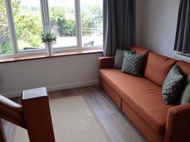 A living room with a sofa and a view outside at Horse Gin in Parkend