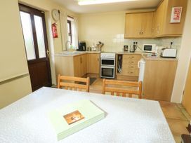 A kitchen with cabinets and appliances at Getws Ty Croes