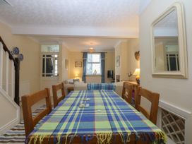 A dining room with a table and chairs at 15 Rose Hill in Beaumaris